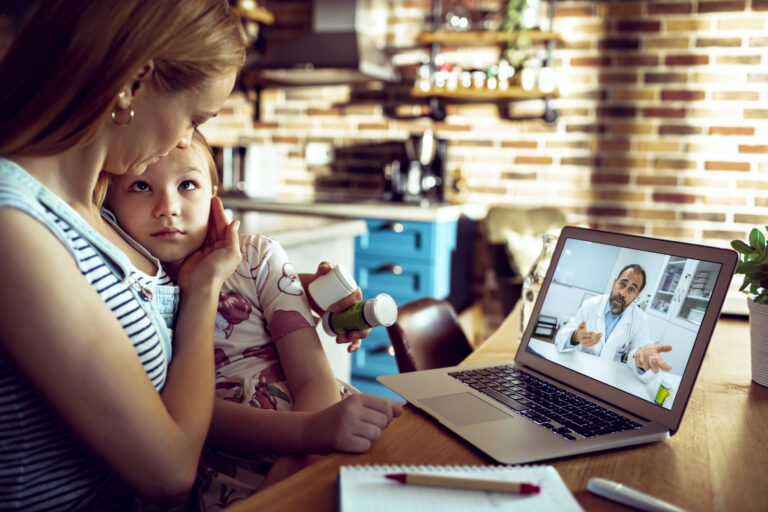 adult and child participating in a telehealth session