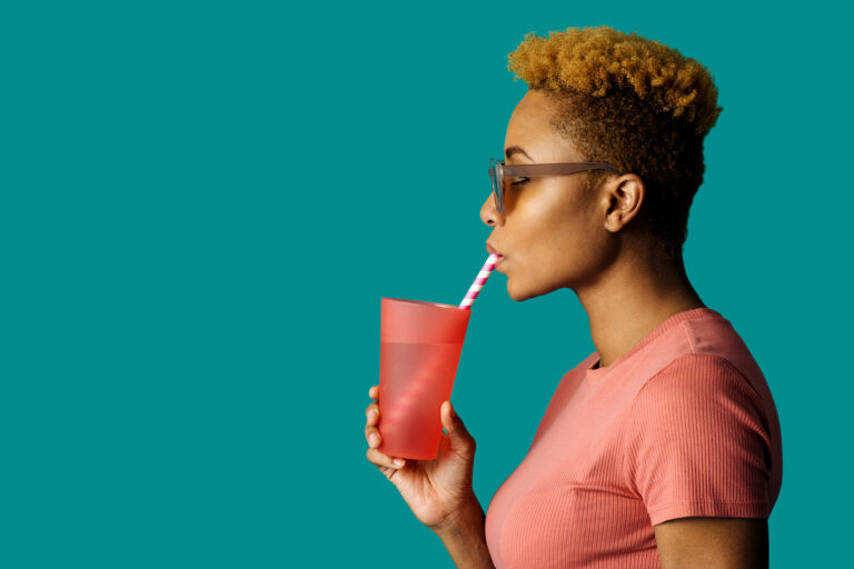 24 09 18 a person drinking through a straw that is in a glass filled with liquid mf dload gettyimages 1255751395 1200x800 5b2df79