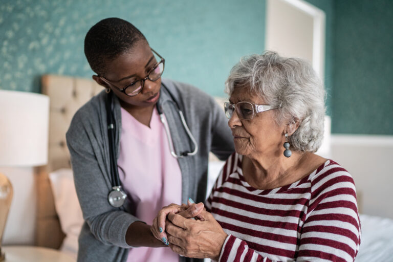 doctor holding elderly patients hand