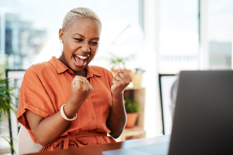 person celebrating victory while looking at computer