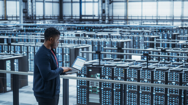 person with a tablet in a data center