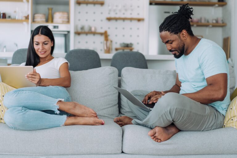 two people use devices at home getty