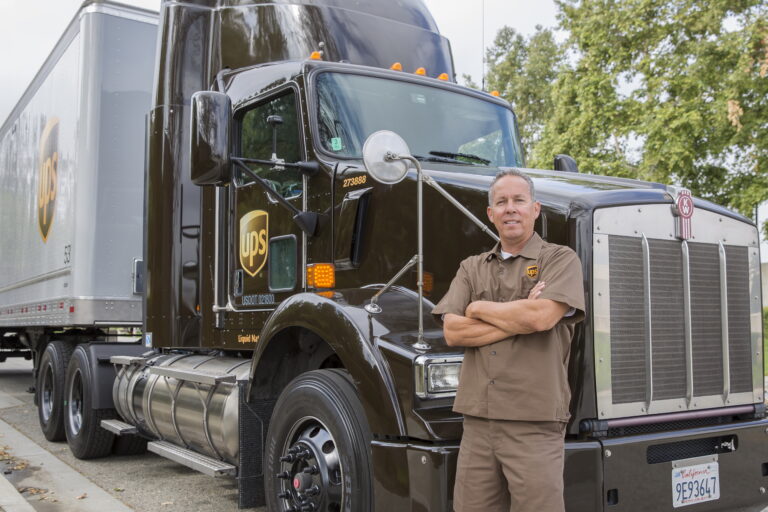 ups driver in front of truck image source ups