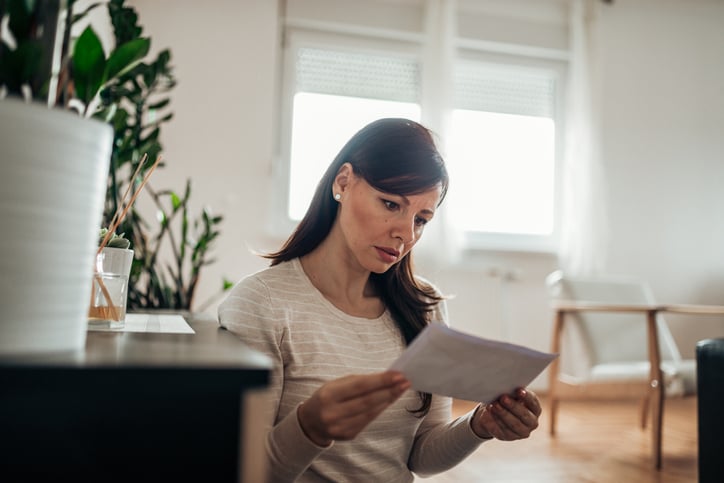 worried woman reading letter