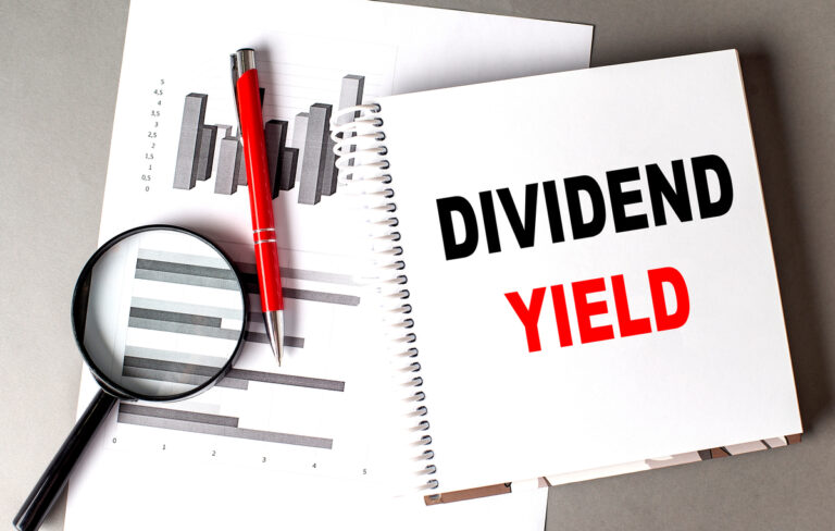 24 10 11 the words dividend yield in a notebook sitting on top of paper with a graph on it and a magnifying glass mf dload gettyimages 1952457434 1201x762 95f5f52