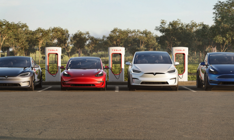 4 teslas in a parking lot at a charger station