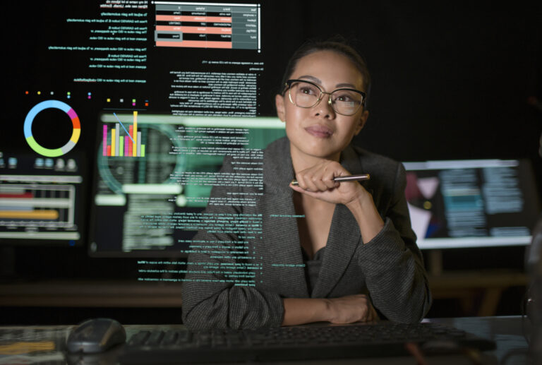 a person studying a see through display of various charts and graphs