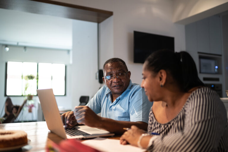 adults looking at financial paperwork