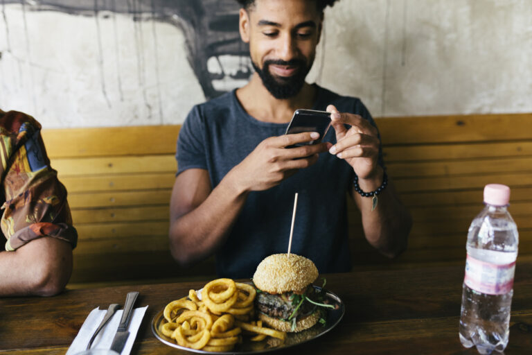 guy taking photo of burger