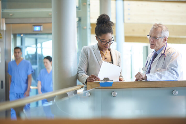 medical professionals conferring in a hospial corridor