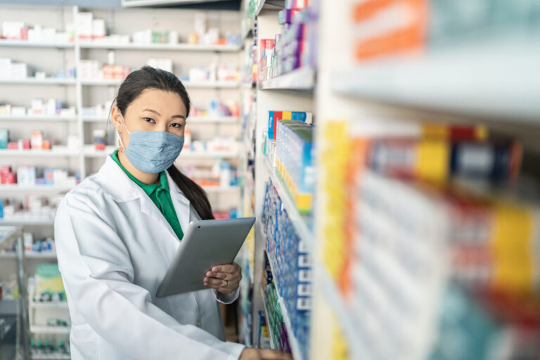 pharmacist stands in pharmacy