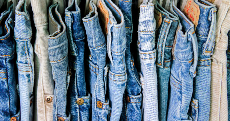 row of levis blue jeans hanging up