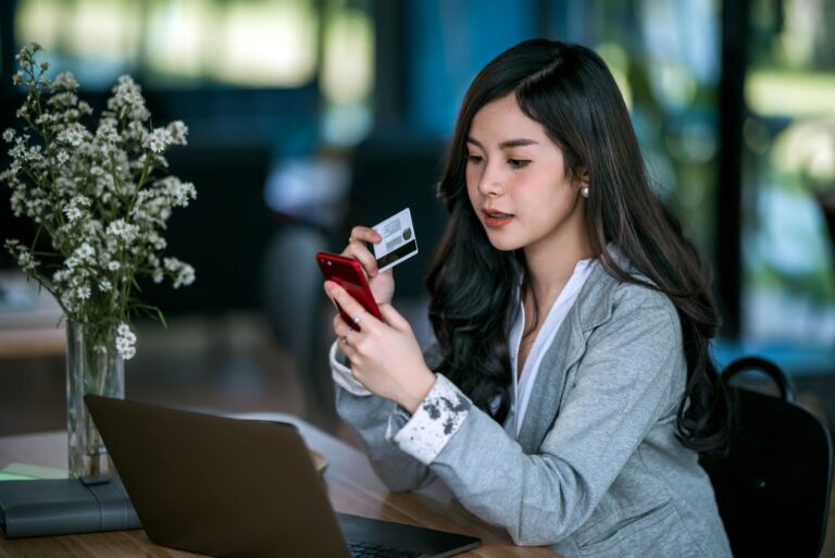 a person using their credit card to shop online