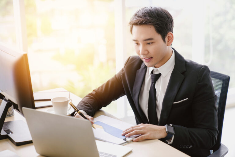 businessman with a chart looking at his computer