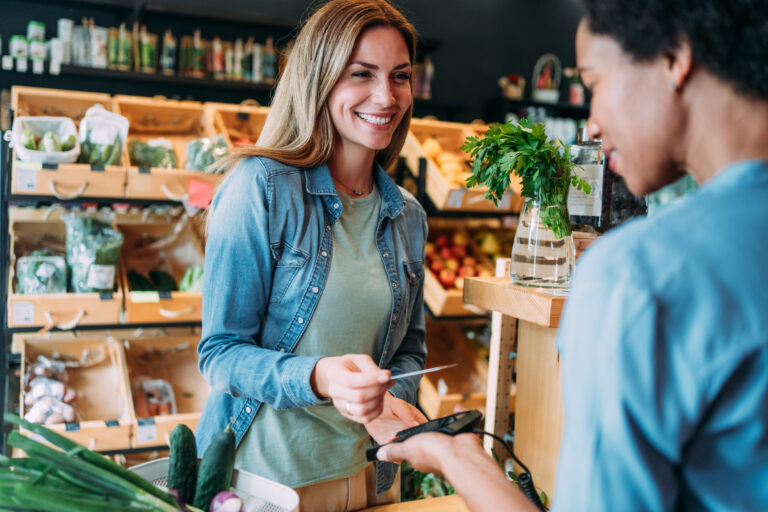 person making a purchase in a store with a payment card