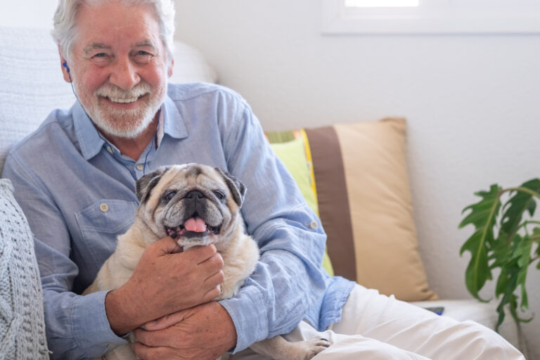 smiling person holding dog gettyimages 1326614891