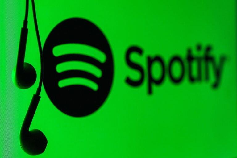 spotify logo sign with earbuds spot