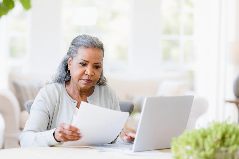 older woman document laptop