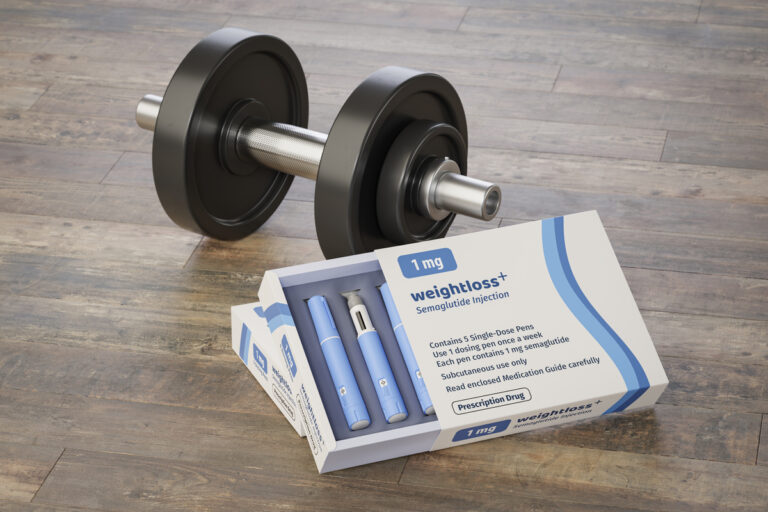 package of weight loss drug next to a barbell