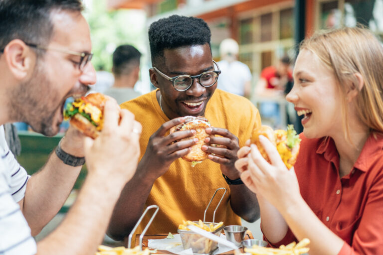 people eating hamburgers fast food