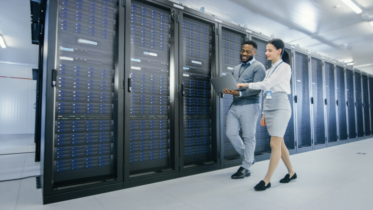 two technicians in data center aisle