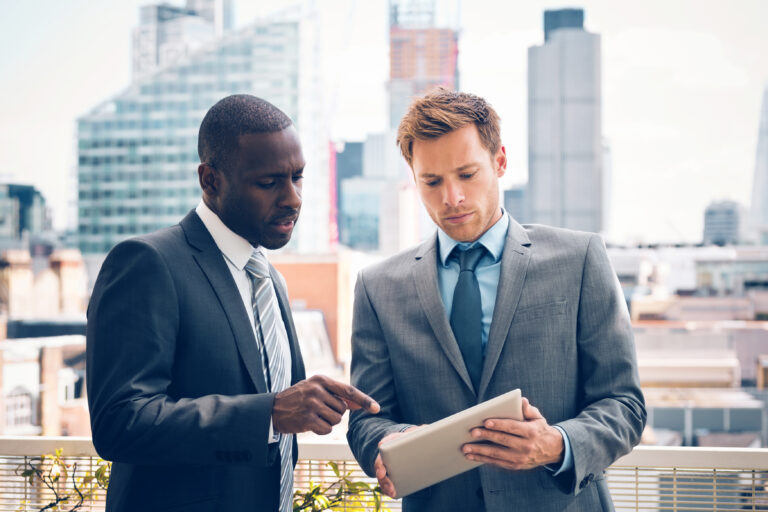 business people looking at a tablet