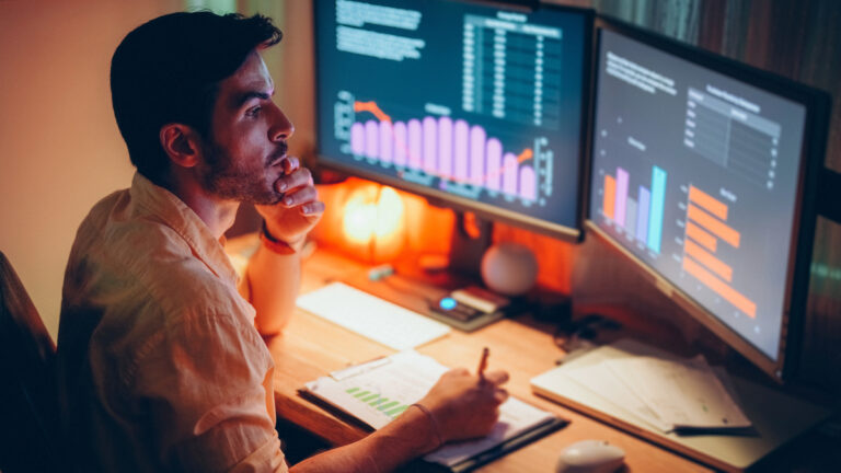 investor taking notes stock charts 1200x675 128554e