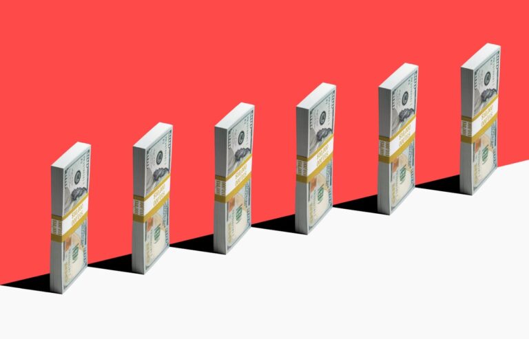 Money bundles lined up on red