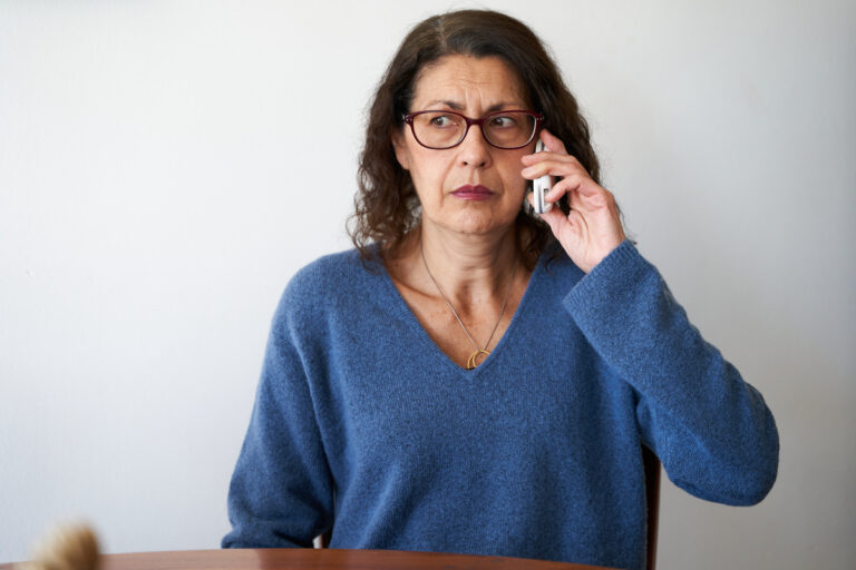 confused person using cell phone
