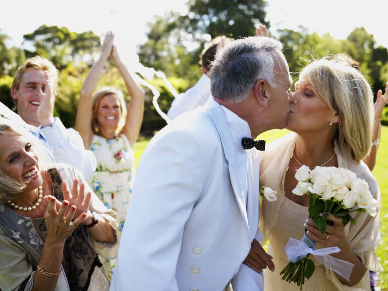 mature couple getting married kiss with bouquet