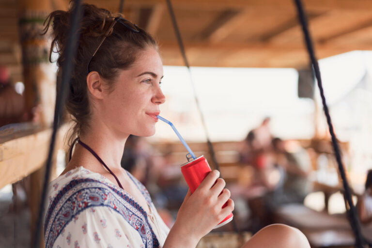 person drinking cola in a car
