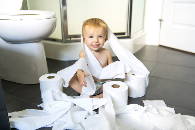 22 02 07 a small child sitting in a pile of toilet paper gettyimages 1070041534